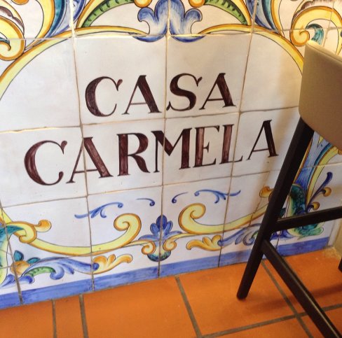 A tiled sign reads "Casa Carmela"offering the name of the paella restaurant we enjoyed in Valencia Spain.
