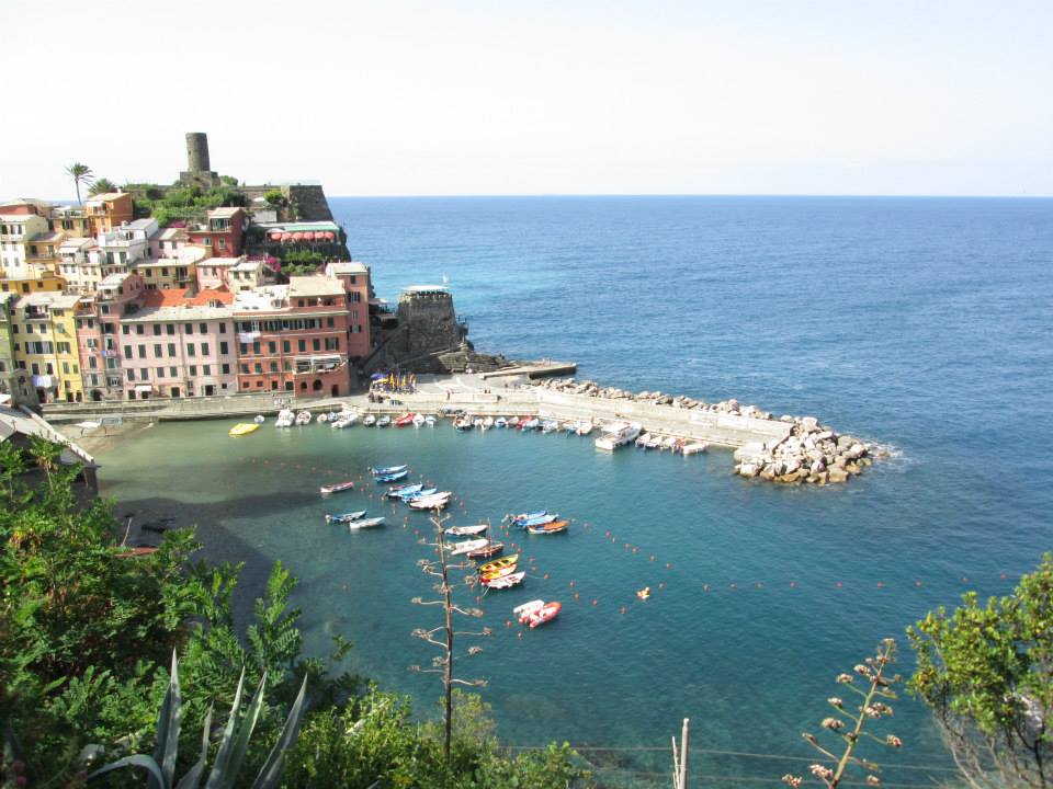 A view of the port in Vernazza showcasing the boats on the water.